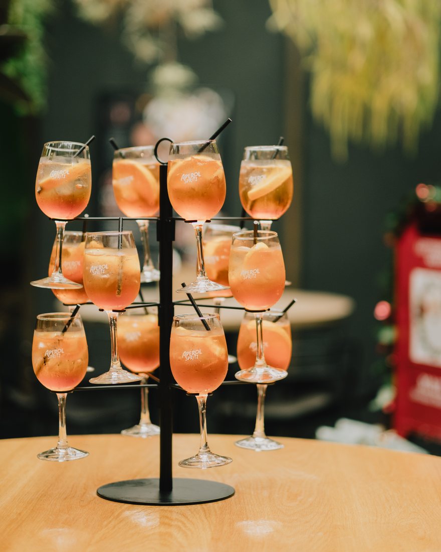 A tiered stand of Aperol Spritz glasses garnished with orange at The Terminus Hotel